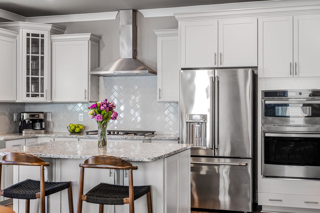 The Art of Drawing Readers In: Your attractive post title goes here Bright modern kitchen with stainless steel appliances and white cabinets.
